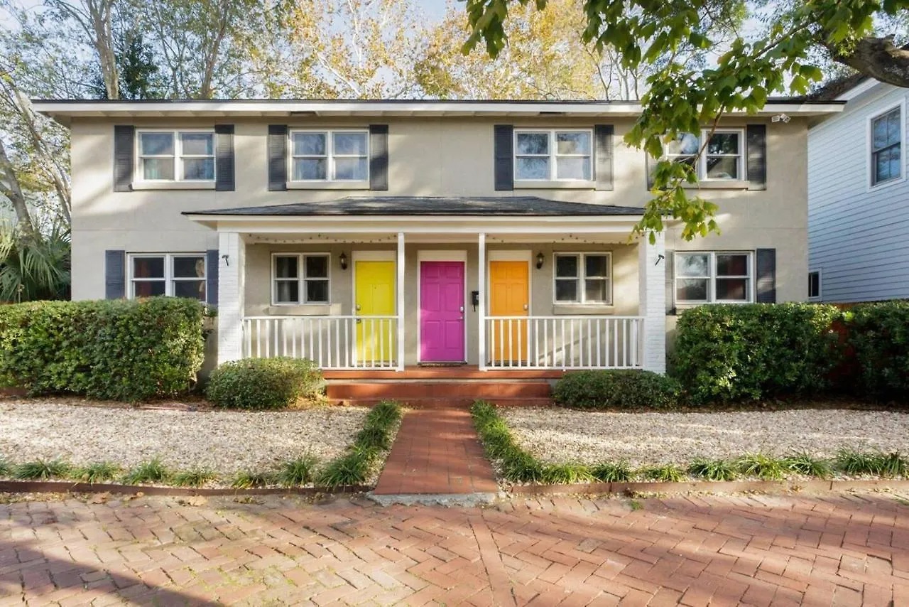 Vibrant, Colorful Building With Backyard Firepit And Games Apartment